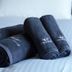 Minamisenri Crystal Hotel in Suita with rolled dark navy towels on a bed