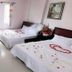 Ban Mai Hotel 66 in Phan Thiet: twin beds with rose petals in a simple guest room