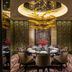 Four Seasons Hotel Shenzhen dining room with round table, gold ceiling sculpture and mirrored walls