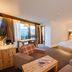 Vier Jahreszeiten Am Schluchsee room with twin beds, seating area and lake view balcony in Schluchsee
