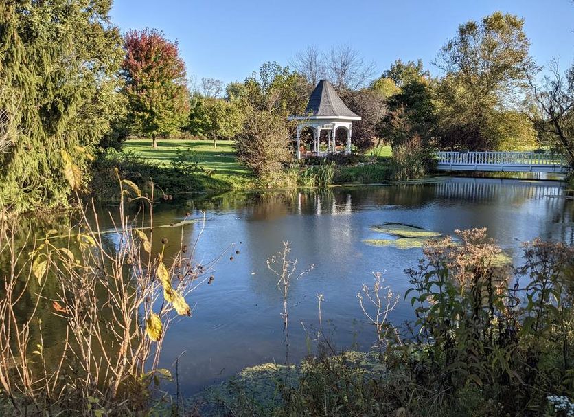 Inntiquity, A Country Inn in Logansport with a peaceful pond and gazebo surrounded by autumn trees