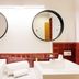 B&B Hotel Palermo Quattro Canti bathroom with double sinks and round mirrors in Palermo