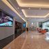 Xiamen Junming Hotel lobby in Xiamen with marble floors, modern ceiling lights, and orange seating