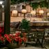 Kenta Beach Hotel in Agios Ioannis outdoor lounge with bar seating, hanging lights and flowers