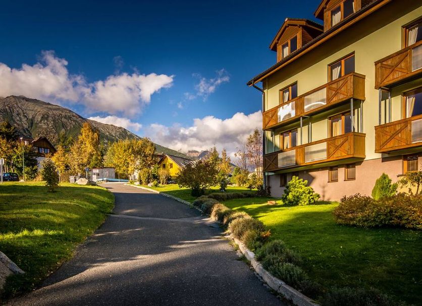 Hotel Villa Siesta in Vysoké Tatry with mountain views and a paved path beside the hotel