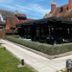 The Carrington Arms in Newport Pagnell, brick pub-style hotel with outdoor seating and hedge-lined patio