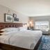 Four Points by Sheraton Elkhart guest room with king bed, desk, wall TV and window view