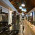 Narita Hotel Tulungagung dining area with long tables, pendant lights, and buffet counter