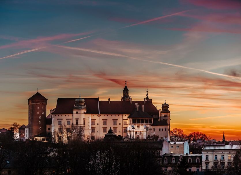 Queen Boutique Hotel in Krakow at sunset with a historic castle-like facade and skyline view