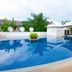 Nadivana Serviced Apartment in Krabi with a curved outdoor pool and tropical landscaping