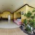 Sunny Point Hotel, Davao City lobby seating area with plants and tiled floor