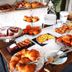 Breakfast buffet at Albaruja Hotel in Costa Rei with croissants, pastries, fruit, and cakes