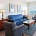 Royal Floridian Resort by Spinnaker in Ormond Beach living room with ocean view, blue sofa, chairs and coffee table