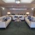 La Quinta Inn and Suites Fort Myers I-75 lobby seating area with sofas, lamps and coffee table