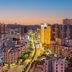 Marriott Hotel Yunfu city skyline at dusk with a lit main avenue and surrounding high-rises