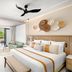 Secrets Tides Punta Cana room with king bed, sofa, balcony and tropical view in Uvero Alto