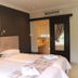 3 Liebeloft Guest House in Johannesburg room with twin beds, artwork, and doorway to a bathroom