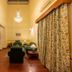 Umed Bhawan Palace in Kota suite with chandelier, seating area, bed alcove and floral curtains