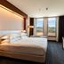 Delta Hotels by Marriott Olbia Sardinia guest room with king bed, desk and mountain views in Olbia