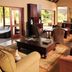 Pilanesberg Private Lodge in Pilanesberg lounge with wicker seating, coffee table and large windows