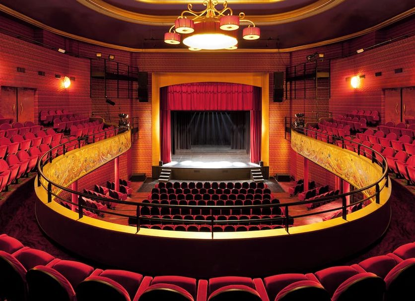 Hôtel Barrière le Grand Hôtel Enghien-les-Bains theater with red seats and a stage in Enghien-les-Bains