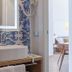 Domus Maris Relais Boutique Hotel in Sciacca bathroom with vessel sink and blue patterned wallpaper
