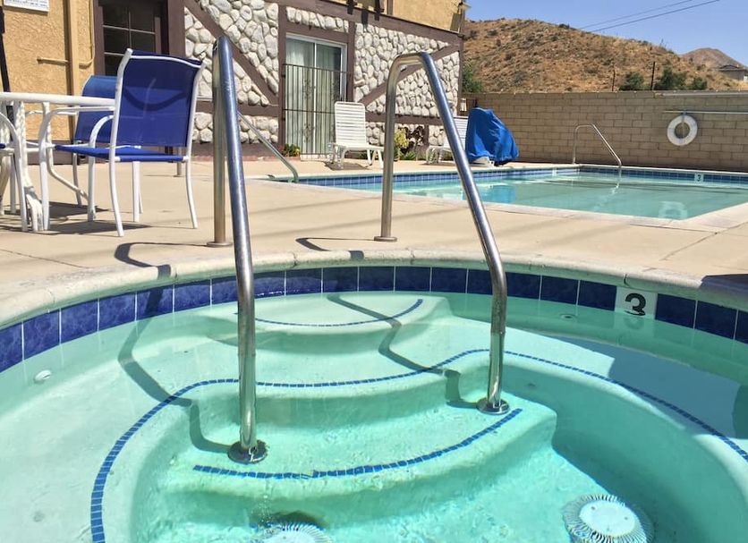 Triplodge of Santa Clarita pool with hot tub and desert hillside view in Forest Park