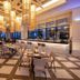 Unique Club at Lopesan Costa Bávaro Resort in Punta Cana dining room with large windows and hanging lanterns