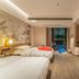 Tian Xing Hotel Chongqing guest room with two beds, wall-mounted TV, and city view through balcony doors