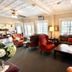 Quaker Inn in Ocean Grove lobby with sofas, armchairs, coffee table, and large windows