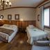 Hotel Solar d'Izabel room in Campos do Jordão with double bed, twin bed, wood floors and chandelier