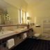 Nordwest-Hotel Bad Zwischenahn bathroom with double sink, bathtub, toilet and shower