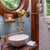 1899 Wright Inn & Carriage House in Asheville bathroom with vessel sink, round mirror, and tiled shower