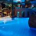 Quality Hotel The Reef in Frederikshavn features a glowing indoor tropical pool with rocks and palm trees