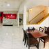 Ramada by Wyndham 100 Mile House lobby with tiled floor, seating area, front desk and staircase