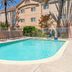 Outdoor pool at Fairfield Inn & Suites by Marriott San Francisco San Carlos in San Carlos with lounge chairs and palm trees