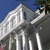 Dansereau House in Thibodaux, white historic hotel facade with tall columns and arched windows