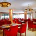 Boma Inn Nairobi in Nairobi restaurant with red chairs, round tables and large windows