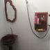 Wood House Pattaya bathroom with wall-mounted shower, sink, mirror, and toiletries in Pattaya