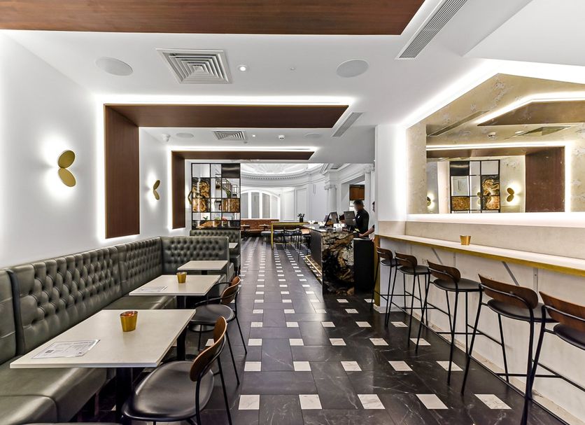 The Z Hotel Holborn in London bar lounge with tufted banquettes, high stools and patterned floor