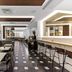 The Z Hotel Holborn in London bar lounge with tufted banquettes, high stools and patterned floor
