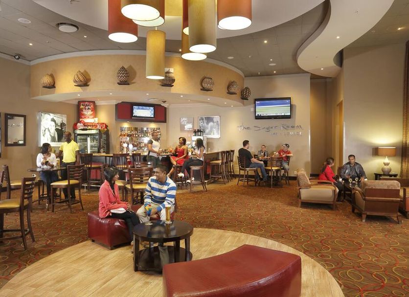 Peermont Metcourt Umfolozi in Empangeni lobby lounge with seating area, bar, and dining tables