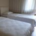 Nur Apart, Marmaris: simple twin guest room with two single beds and sheer curtains by window