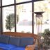 Blue Palmetto Vacation Rentals lobby seating area with wicker sofa, blue cushions, and floor lamp in Myrtle Beach