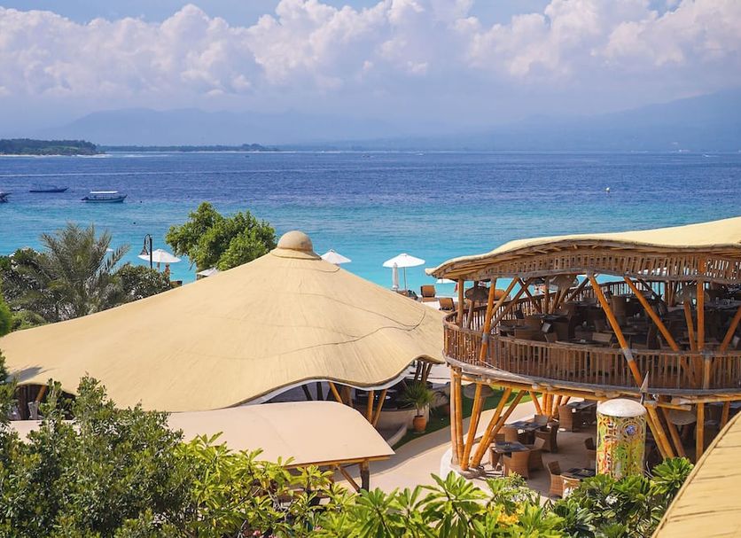 Pearl of Trawangan in Pemenang with ocean view, beachfront deck, and curved thatched rooftop