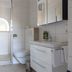 Hotel Weisses Haus bathroom in Bad Kissingen with walk-in shower, wall toilet, and vanity