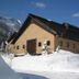 Toyota Shirakawa-Go Eco-Institute in Shirakawa, snow-covered lodge exterior with mountain backdrop