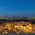 Mestil Hotel & Residences in Kampala at dusk with illuminated buildings and city skyline