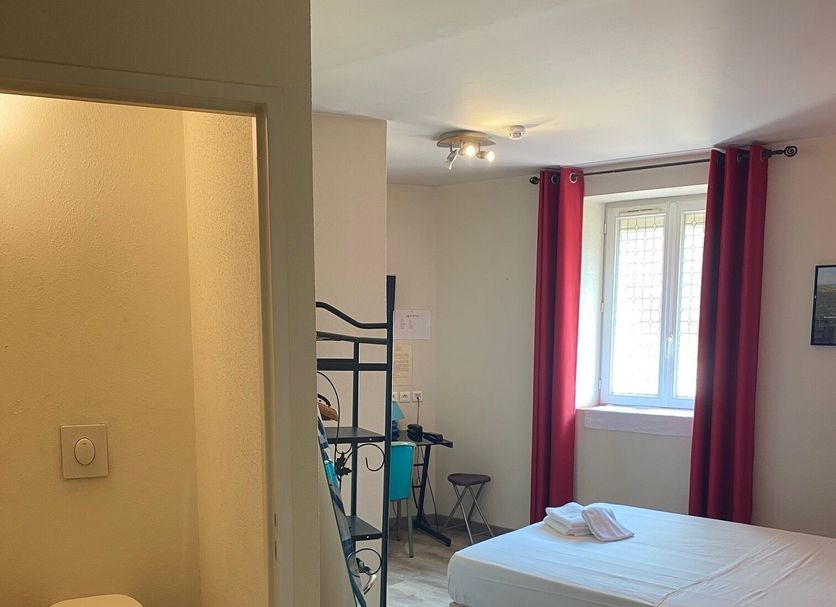 Hôtel Gambetta, Carmaux: guest room with bed, window and en suite bathroom doorway
