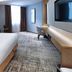Xiamen Miramar Hotel in Xiamen guest room with king bed, desk, chair, and wall-mounted TV